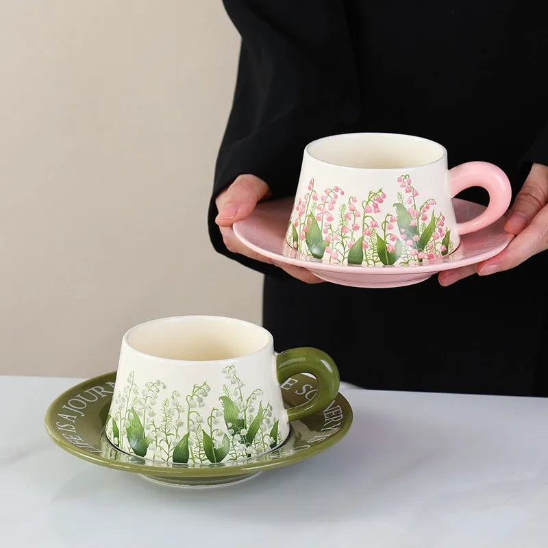 Ceramic coffee cup and saucer set with spoons in hanging bell or Lanling grass couple's cups design.