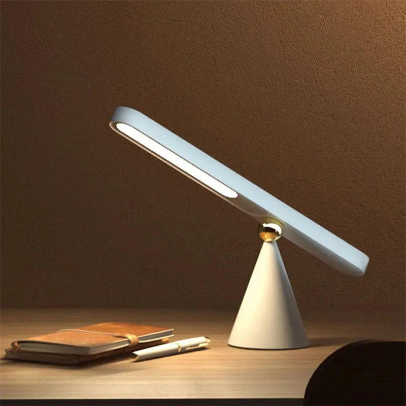 Geometric desk lamp with magnetic base shown in khaki colour with touch control