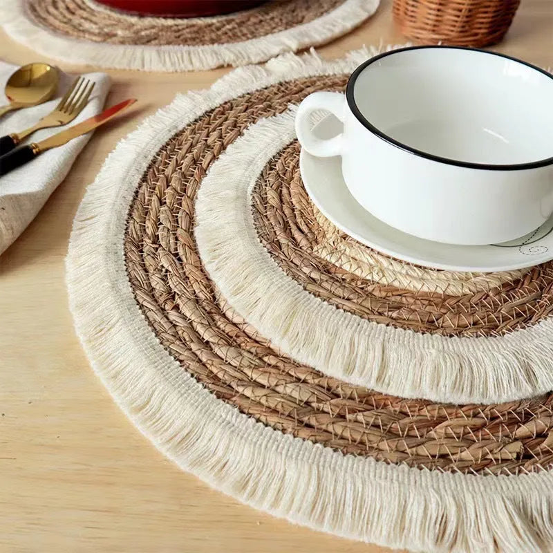 Round natural papyrus straw placemat with tassel detailing in 25cm, 30cm, 33cm, and 38cm sizes.