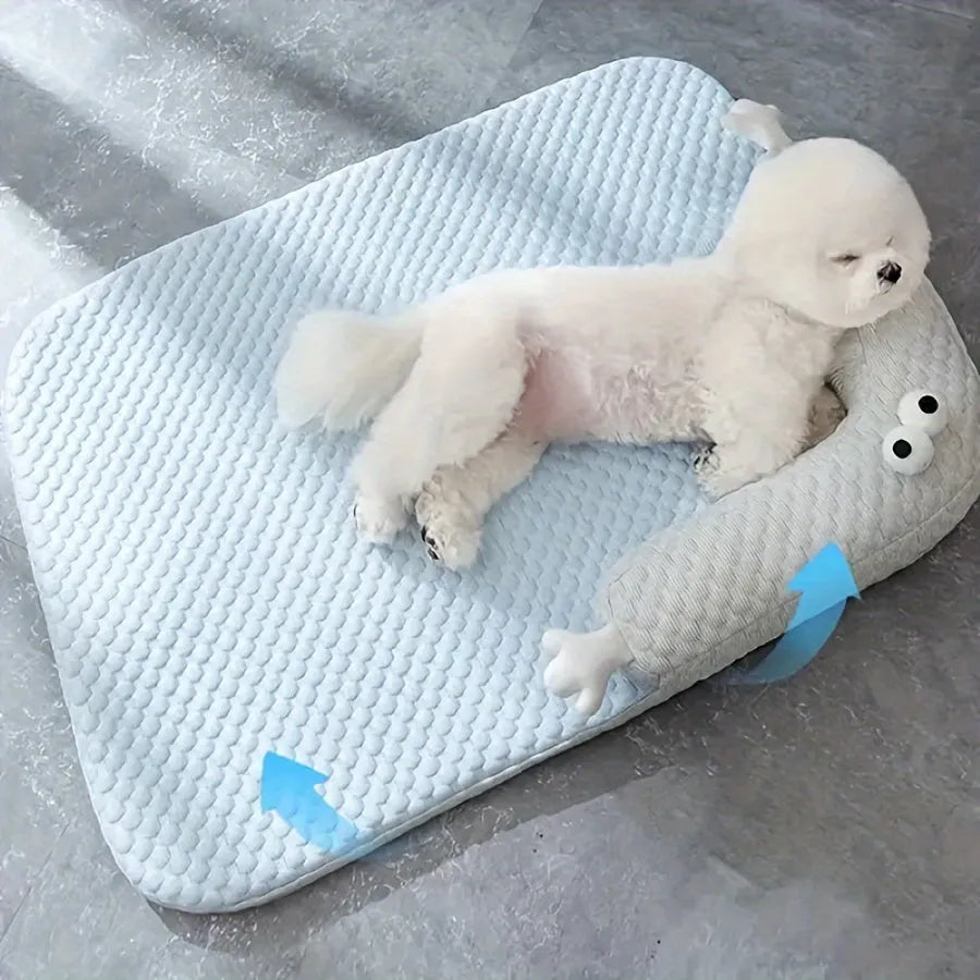 Blue big-eyed monster design breathable pet cooling bed for dogs and cats on a wooden floor.
