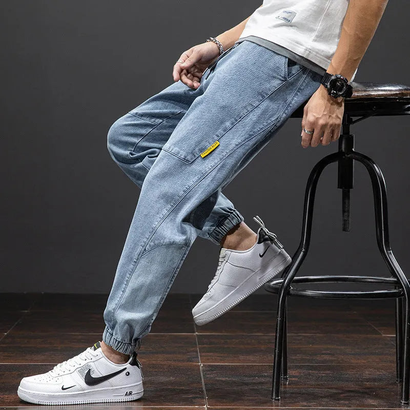 Men's straight leg cargo jeans in blue, showing loose fit, cargo pockets, and mid waist design.