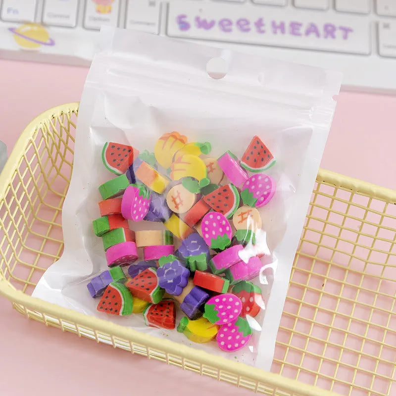 50 small colourful cartoon novelty erasers including fruit and animal shapes in a pearlescent film bag.