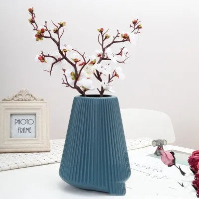 Colourful melamine plastic decorative flower vase measuring 16x20cm on desktop
