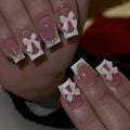 Short white French manicure press-on nails with decorative bow designs and European square shape