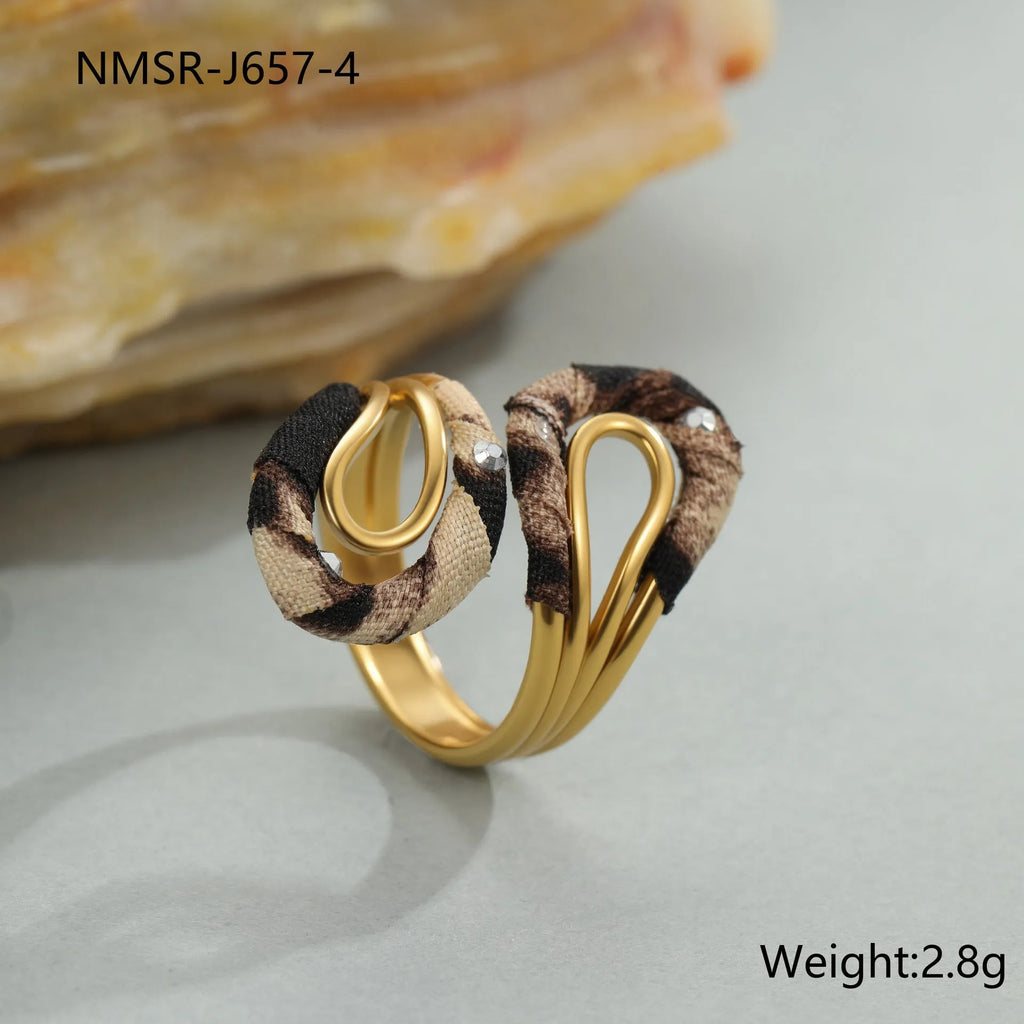 Leopard print stainless steel open mouth ring showing heart, star and geometric shapes.