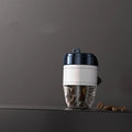 Coffee cup shaped plastic car air freshener in various colours on a car dashboard.