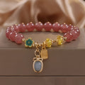 Natural Strawberry Quartz beaded bracelet with rhinestone accents on red alloy base