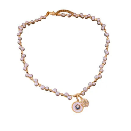 Gold electroplated pendant necklace with zircon stones and imitation pearl centre on clavicle chain