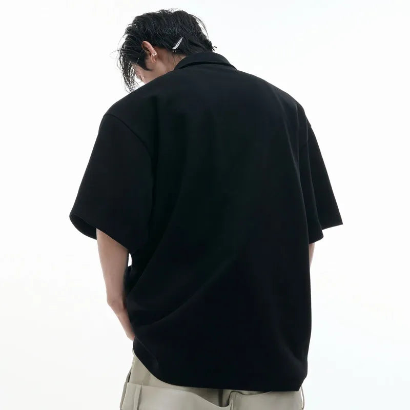 Men's geometric pattern polo shirt with deconstructed collar in grey, shown in a loose fit.