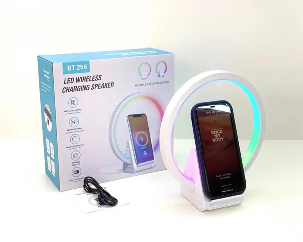 White smart Bluetooth speaker with integrated ambient light and 15W wireless charging pad on top.