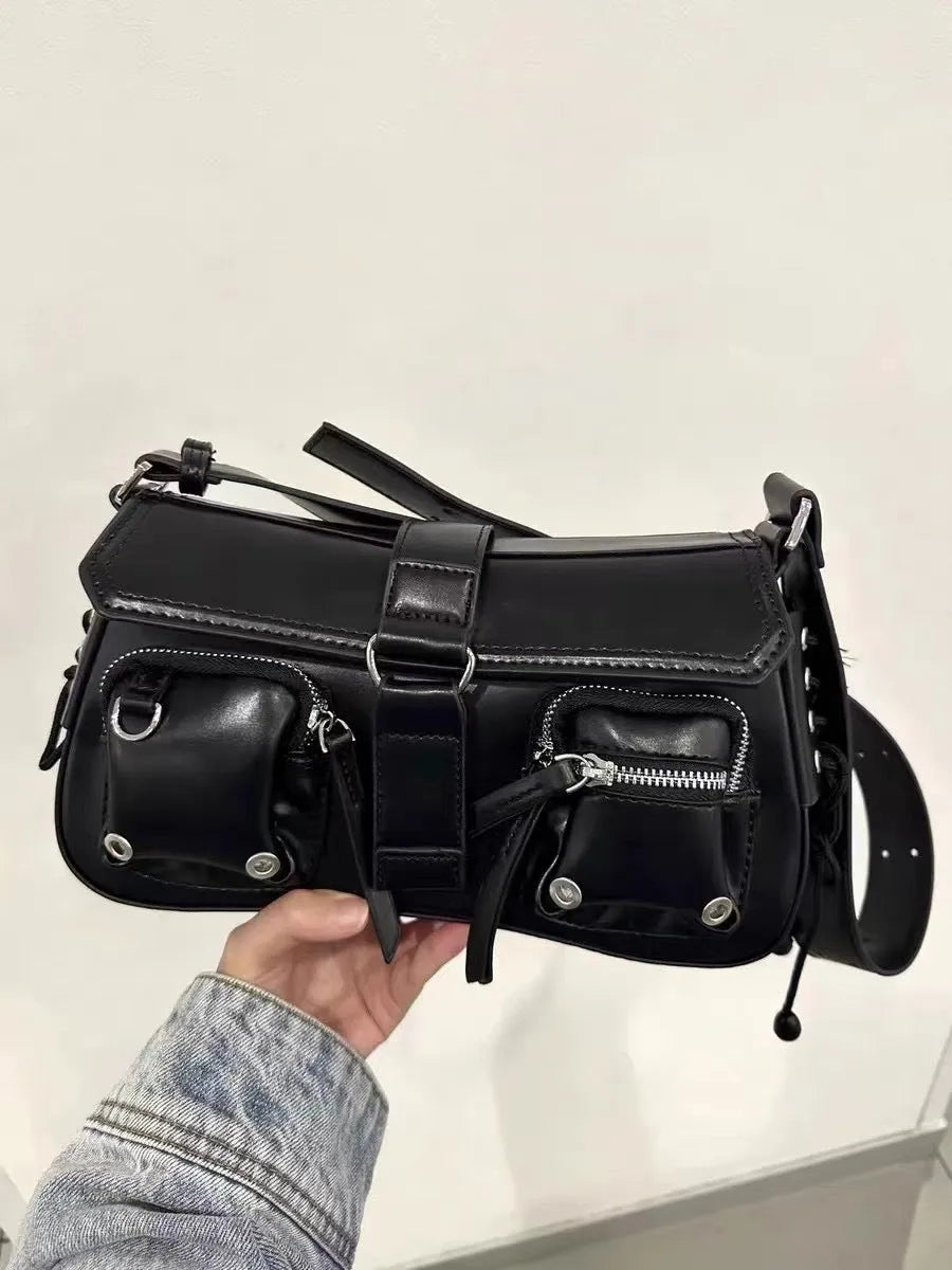 Black underarm baguette messenger bag with adjustable shoulder strap showing structured design