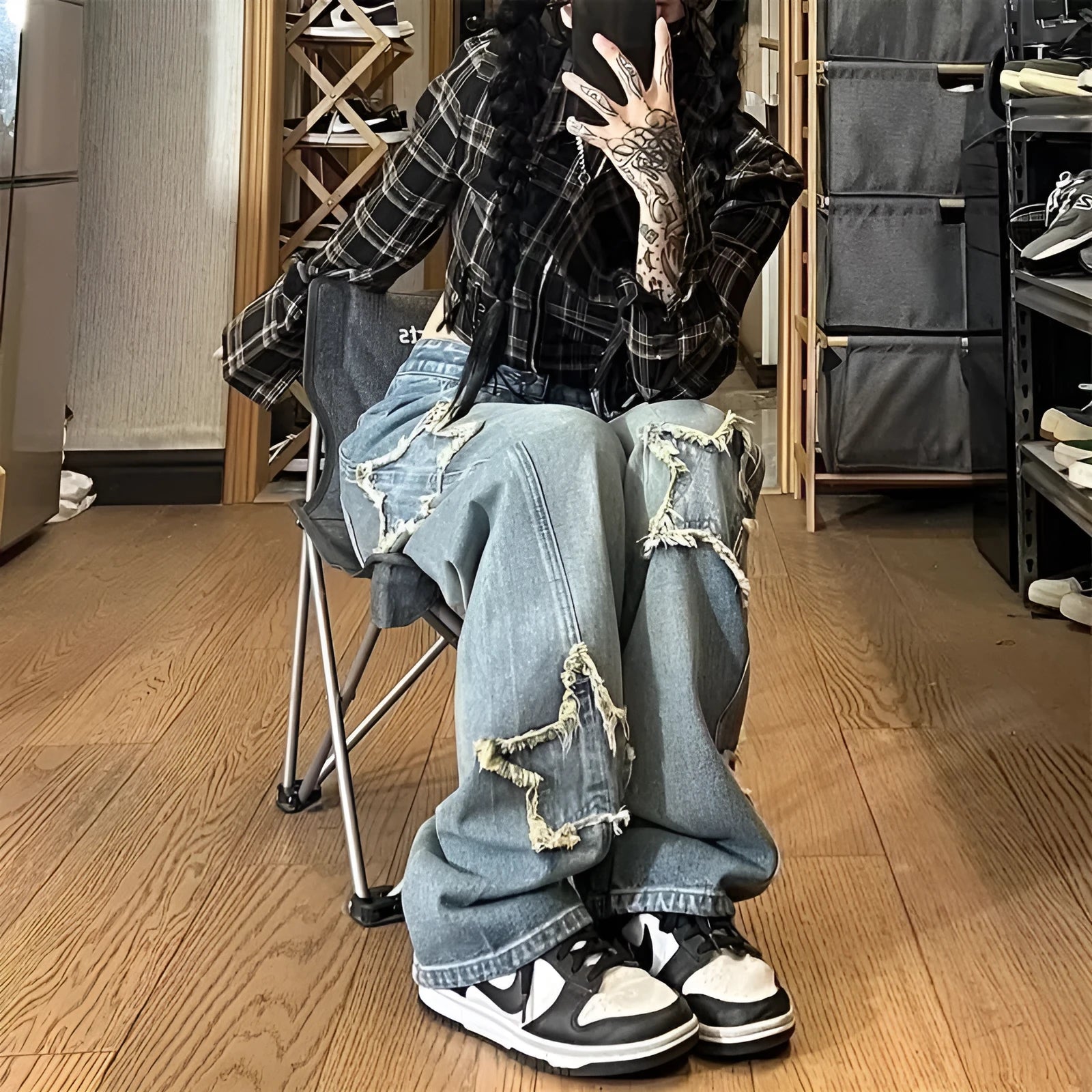 Blue high-waist wide-leg women's jeans on a model, showing the straight-leg cut and denim texture.