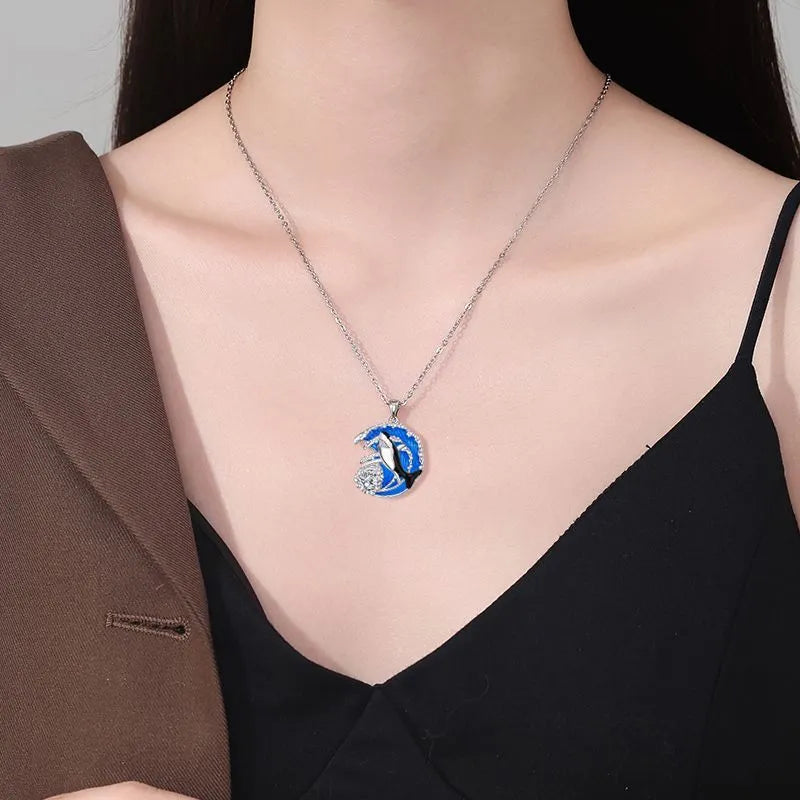 Women's silver-tone necklace with a detailed shark pendant on a cross chain.