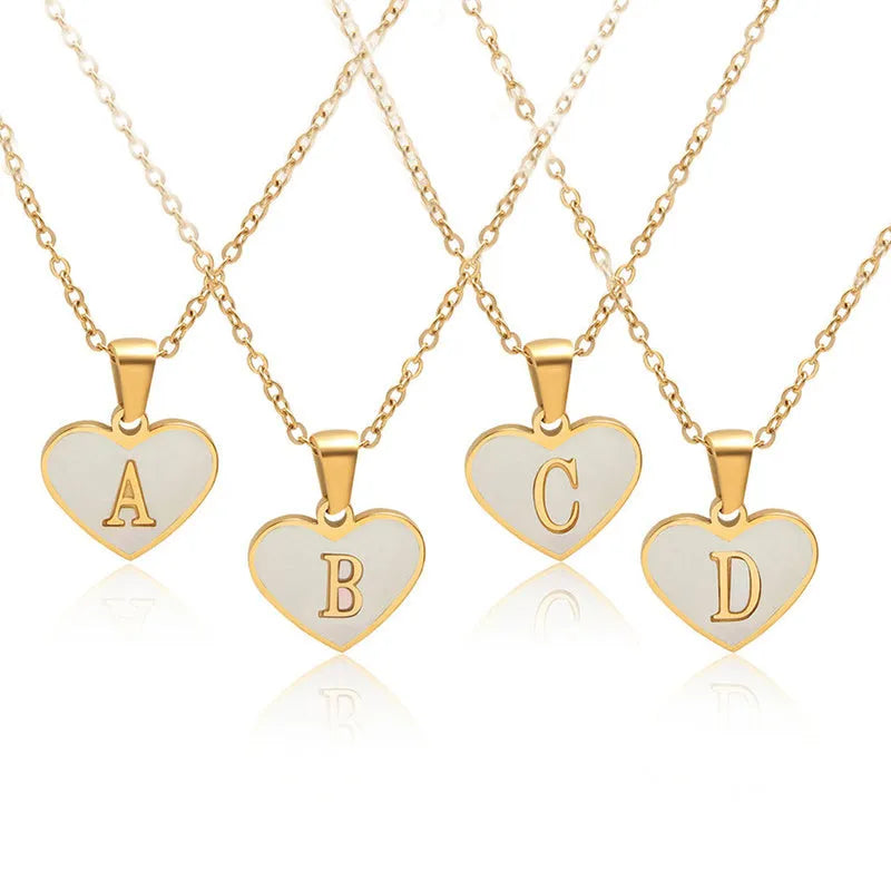 Gold heart necklace with white shell centre on stainless steel chain