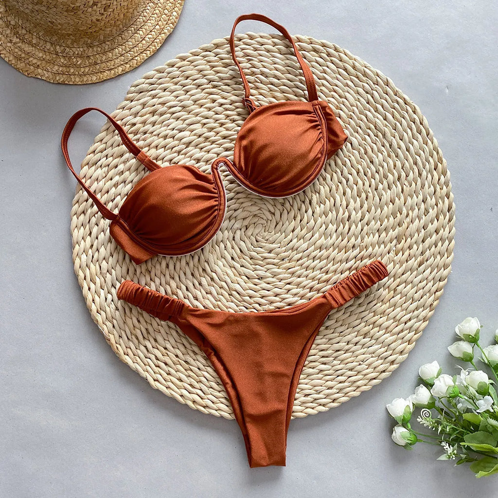 Women's black underwire bikini swimsuit with split briefs, shown on a model.