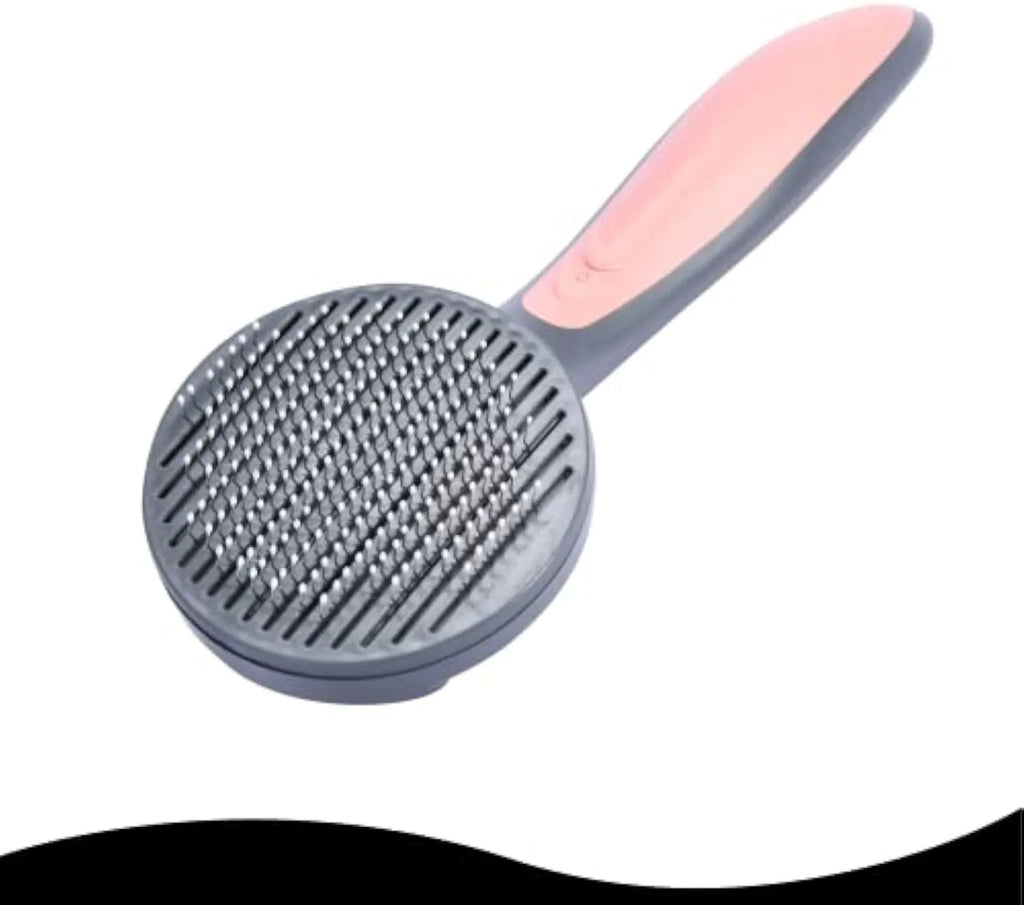 Grey self-cleaning slicker brush for pets with one-click button and comfort-grip handle on a table.