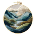 Embroidery kit with printed landscape design fabric, coloured thread, needles, and bamboo frame