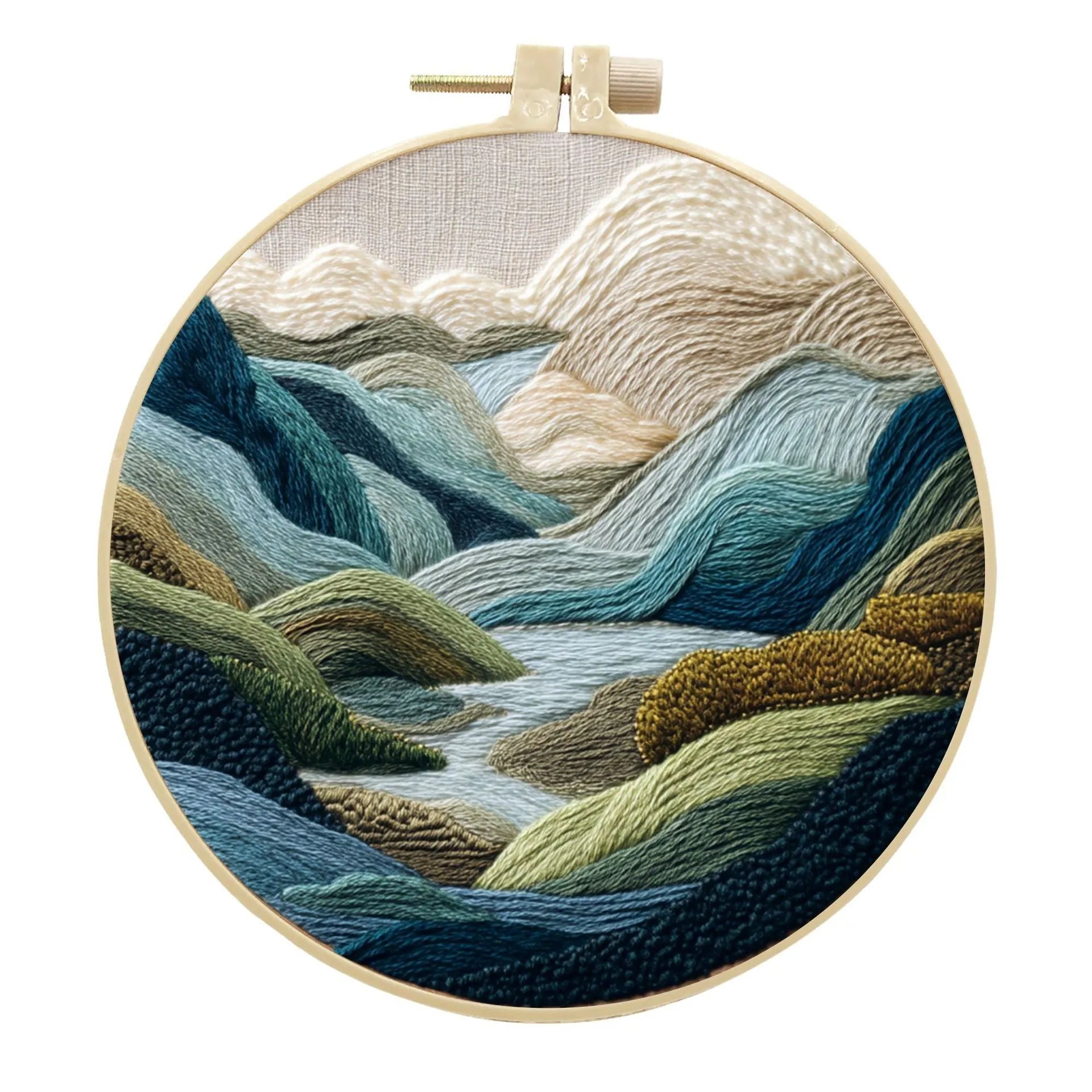 Embroidery kit with printed landscape design fabric, coloured thread, needles, and bamboo frame