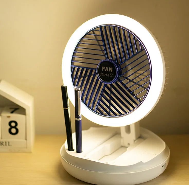 Blue USB foldable table fan with LED night light, pen holder, and four speed settings on a desk