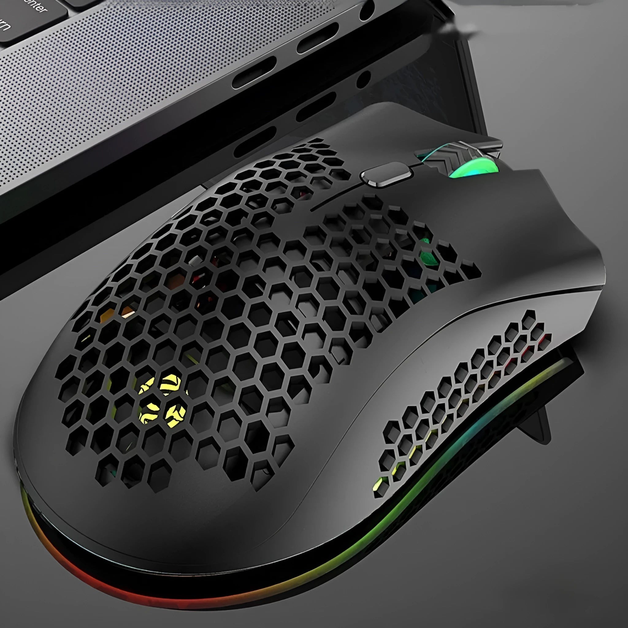 BM600 hollow-out luminous wireless gaming mouse in cyan, black, or white on a desktop.