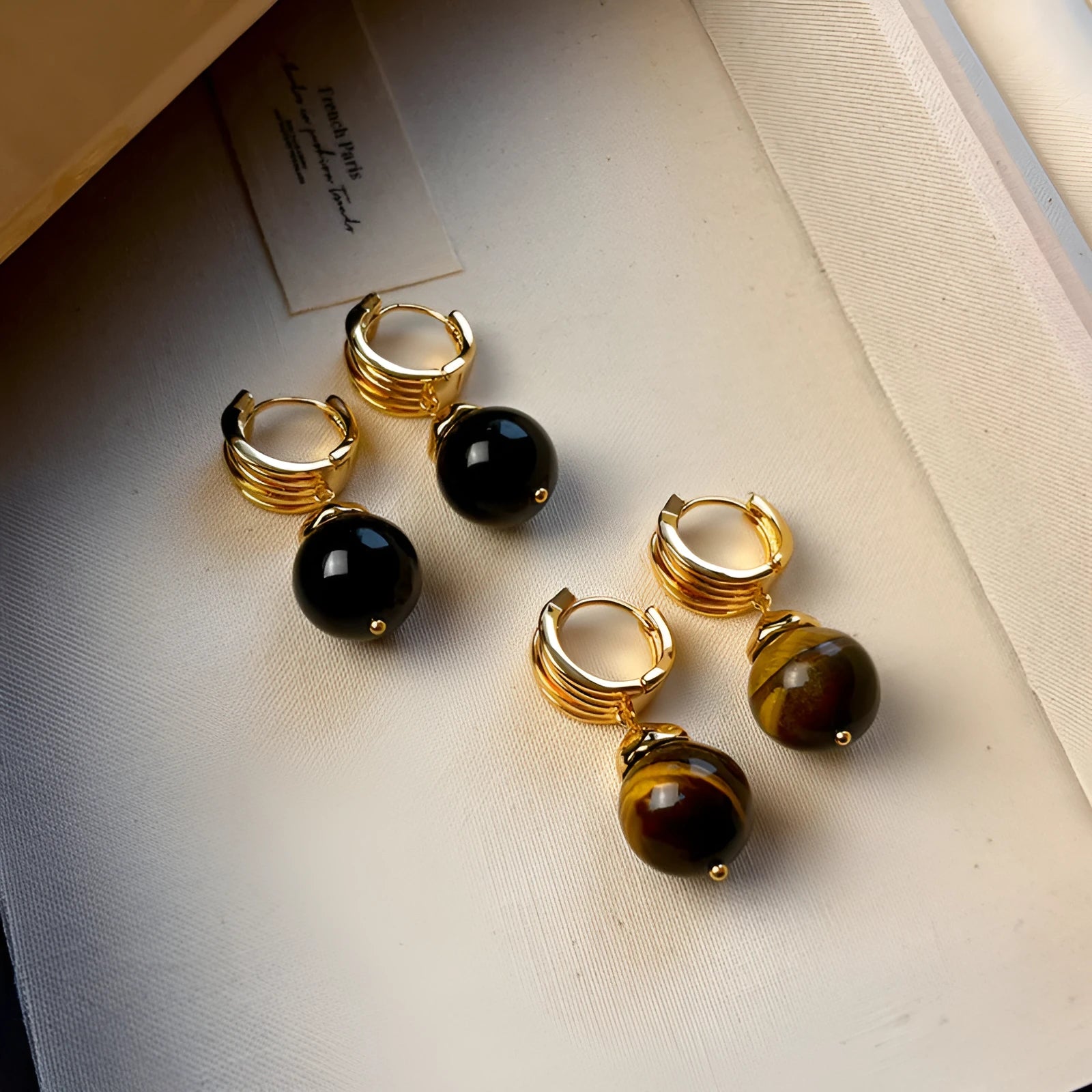 Gold plated geometric drop earrings with round brown tigereye stone, French retro style.