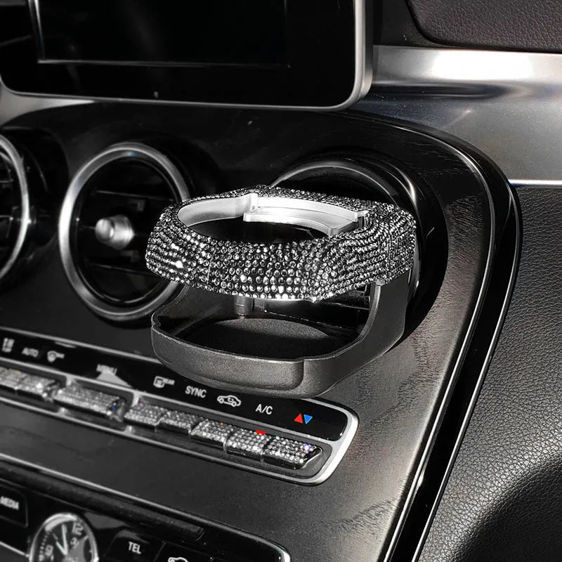 White rhinestone cup holder bracket clipped onto a car air vent
