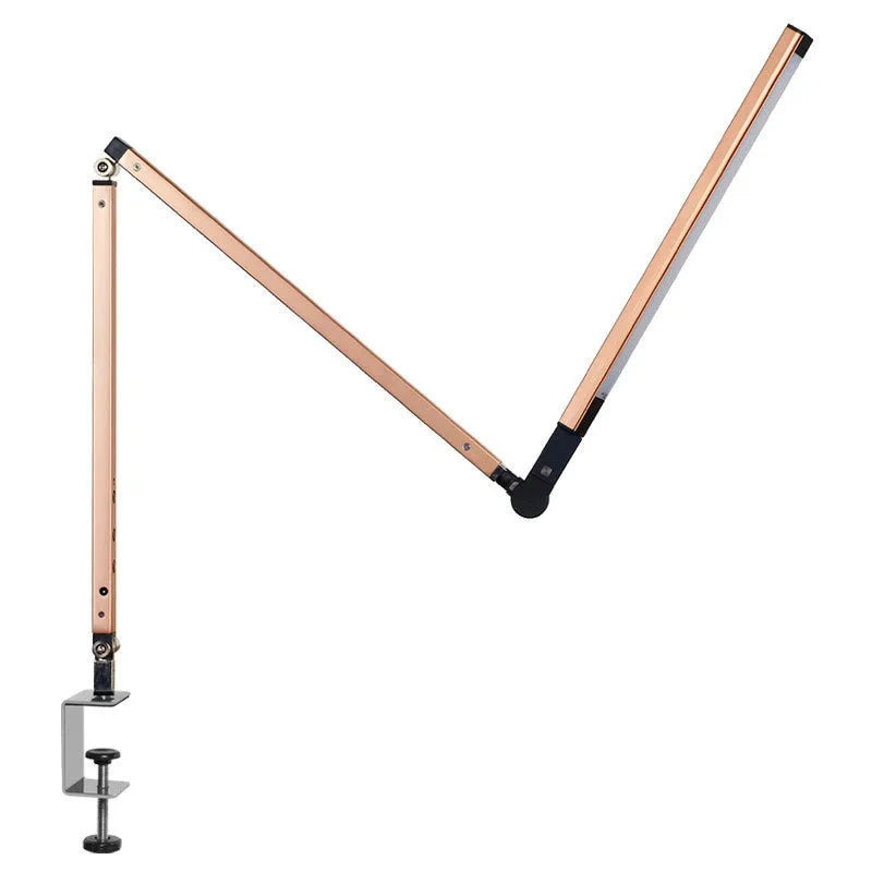Aluminium LED desk lamp with a stainless steel clip mount and remote control on a wooden desk.