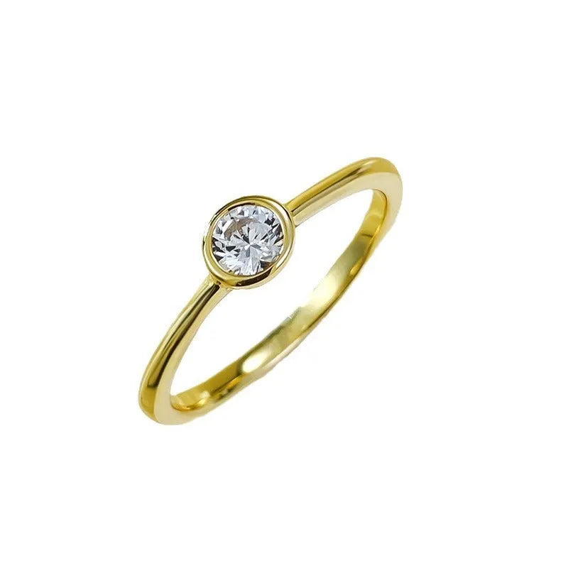 Minimalist crown-shaped silver ring with line detailing on a white background.