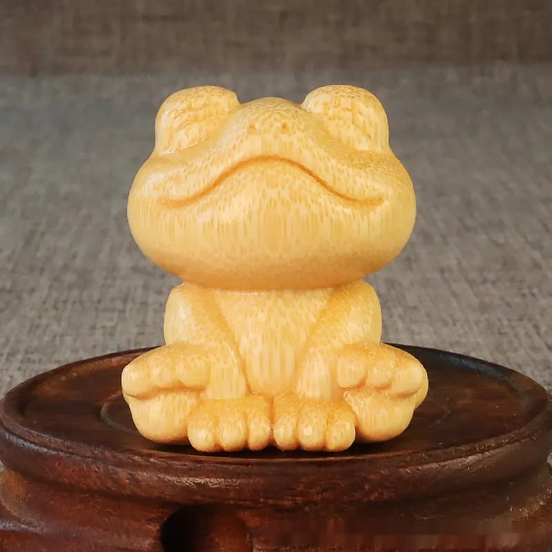 Solid bamboo smiling frog carving ornament measuring 5cm height with cartoon design