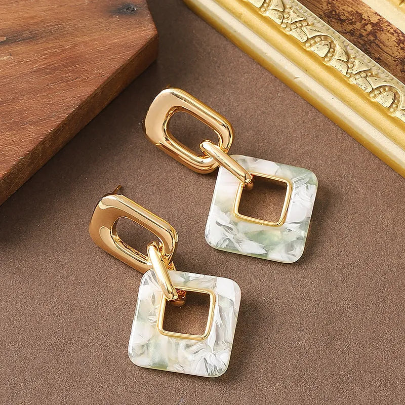 Hollow geometric square earrings in copper with electroplated finish and chamfered corners