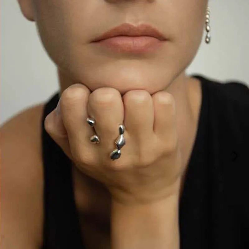 Brass opening ring with spherical element in gold finish on model finger
