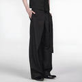 Black straight-leg trousers with single pleat front and adjustable waistband on hanger