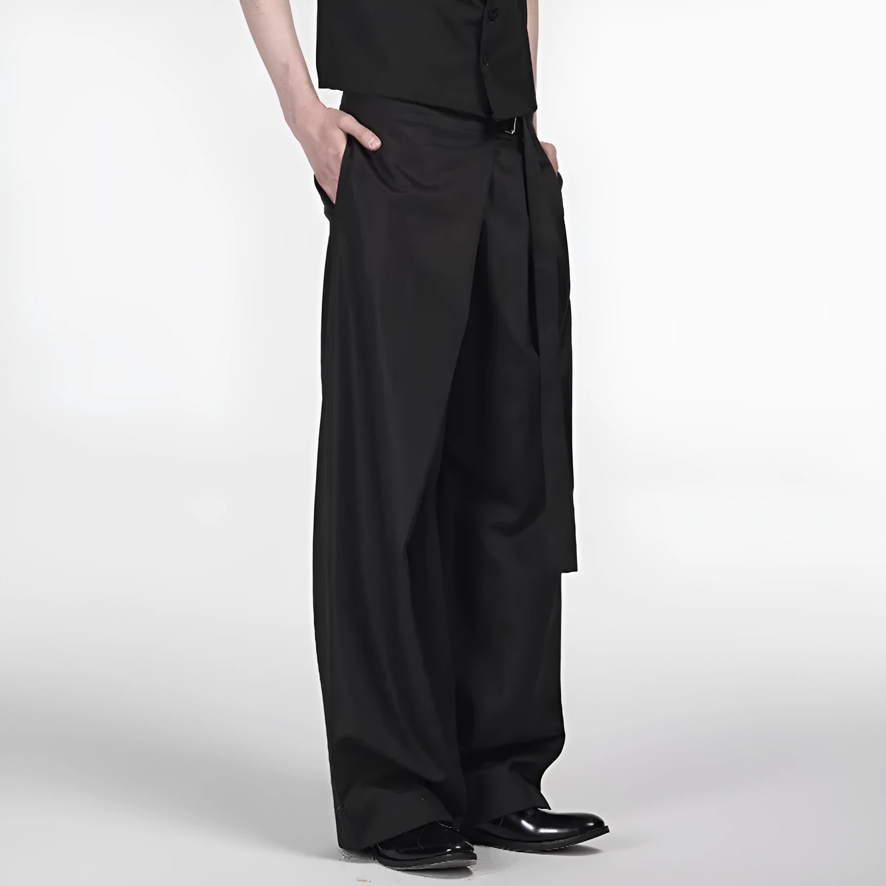 Black straight-leg trousers with single pleat front and adjustable waistband on hanger