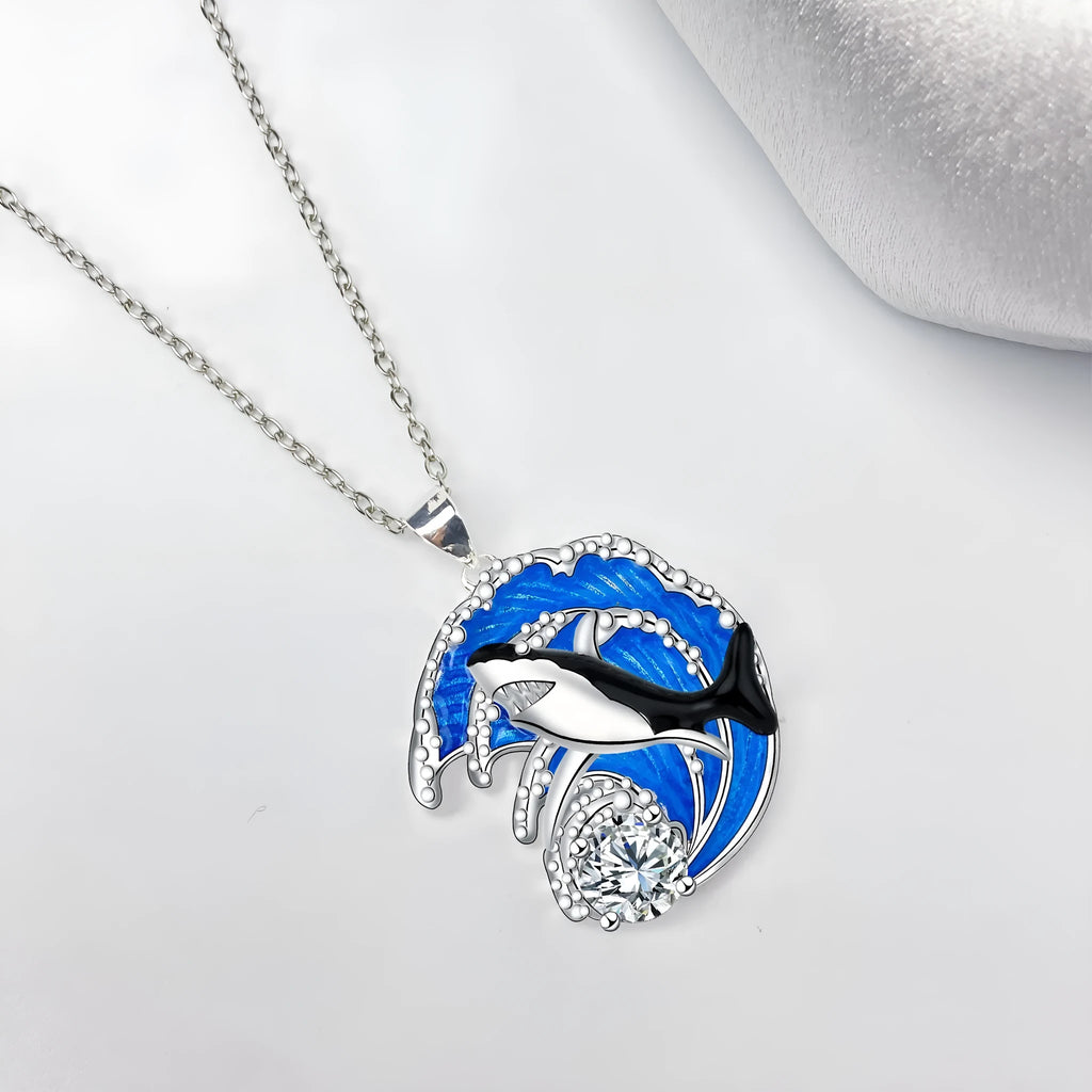 Women's silver-tone necklace with a detailed shark pendant on a cross chain.