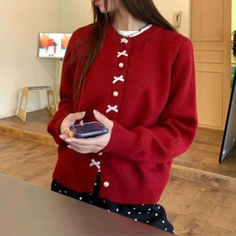 Women's solid colour cardigan with a bow and pearl buttons, in a light yellow acrylic knit.