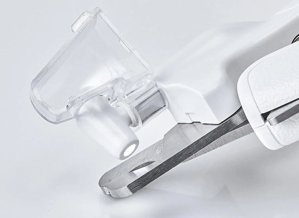 White pet nail clippers with LED light, transparent guard, and a separate nail file on a plain background.