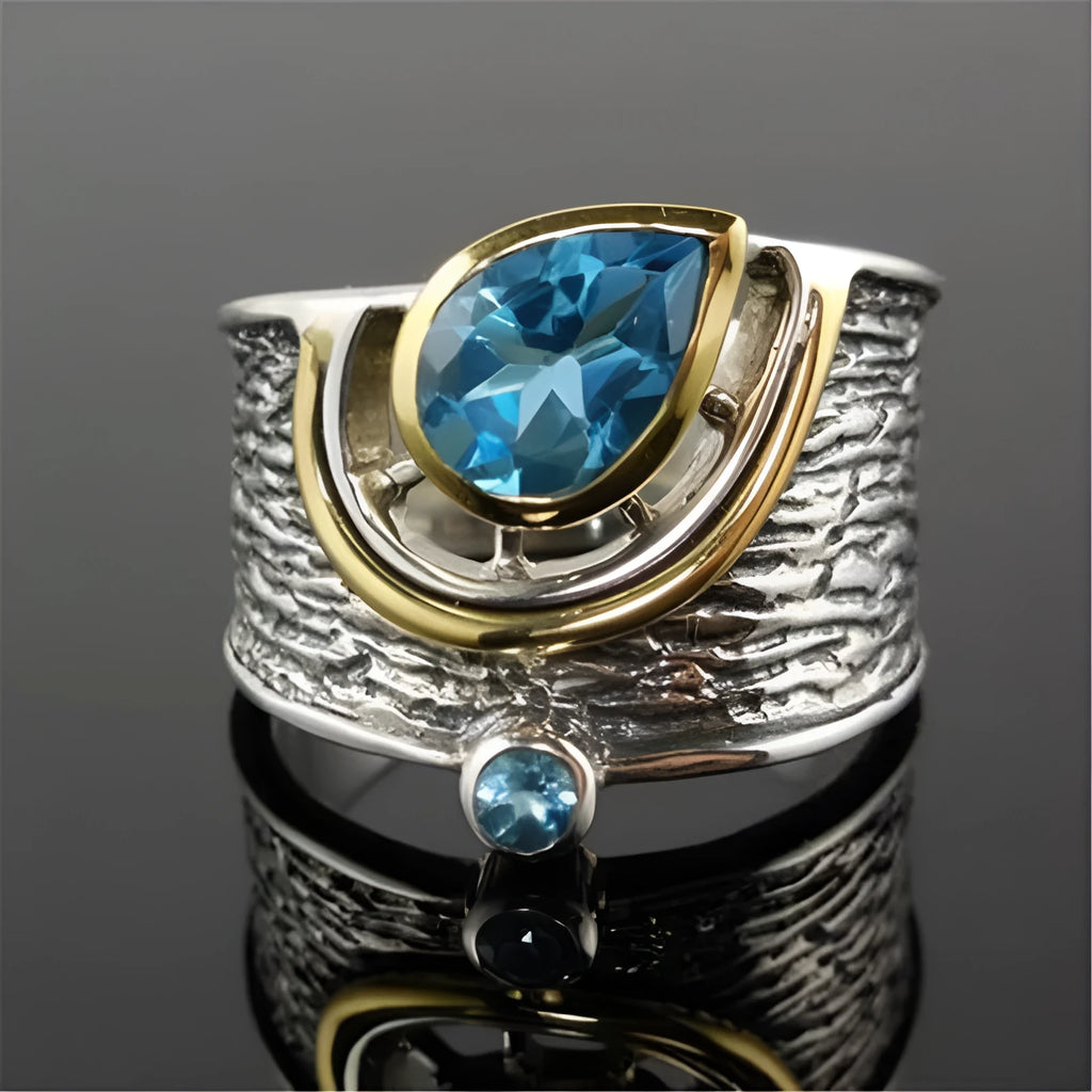 Blue zircon drop shape ring in Creative Chinese Style design, showing inlaid stones on an alloy band.