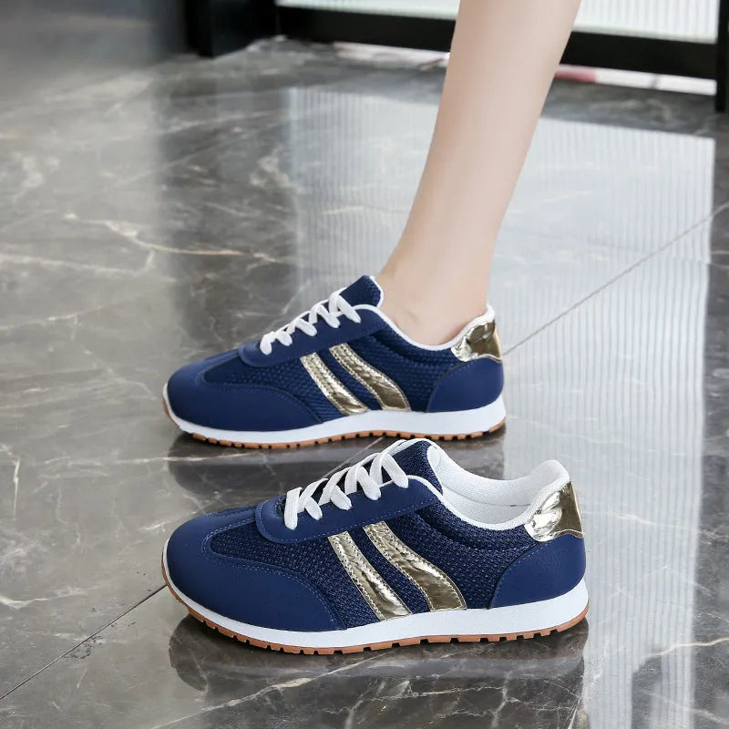 Blue women's casual tennis shoes with cross straps and white rubber sole