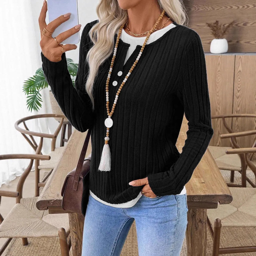 Women's black fake two-piece pullover sweater with a round neck and a button on the shoulder.