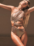 Women's gold backless one-piece swimsuit made from Spandex, shown on a mannequin.