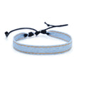 Mixed material denim-style fabric bracelet wristband for carrying travel souvenirs.