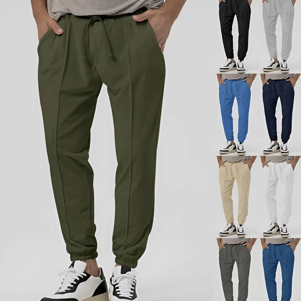 Men's casual track sweatpants in cotton blend fabric showing loose tapered straight-leg design in Army Green colour