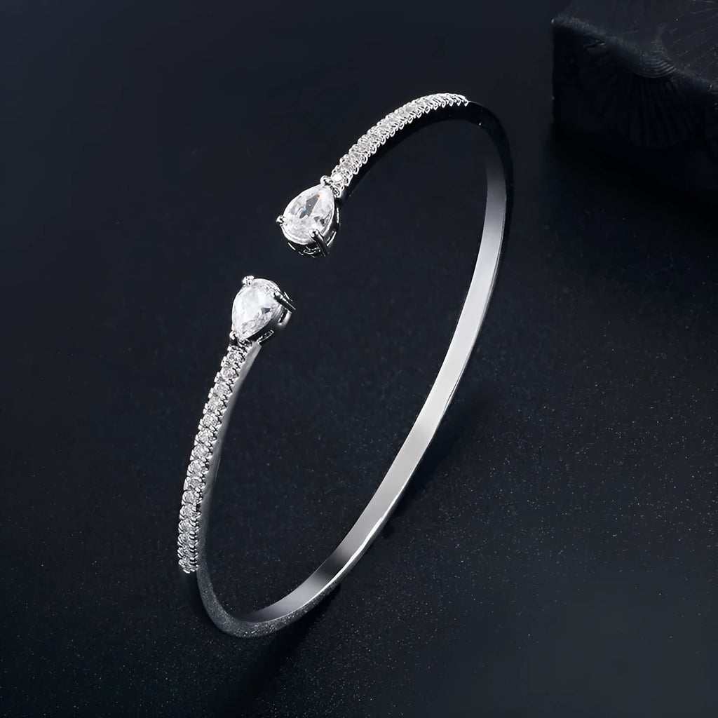 Copper bracelet with inlaid zircon detailing in simple style, shown in white and blue colour options.
