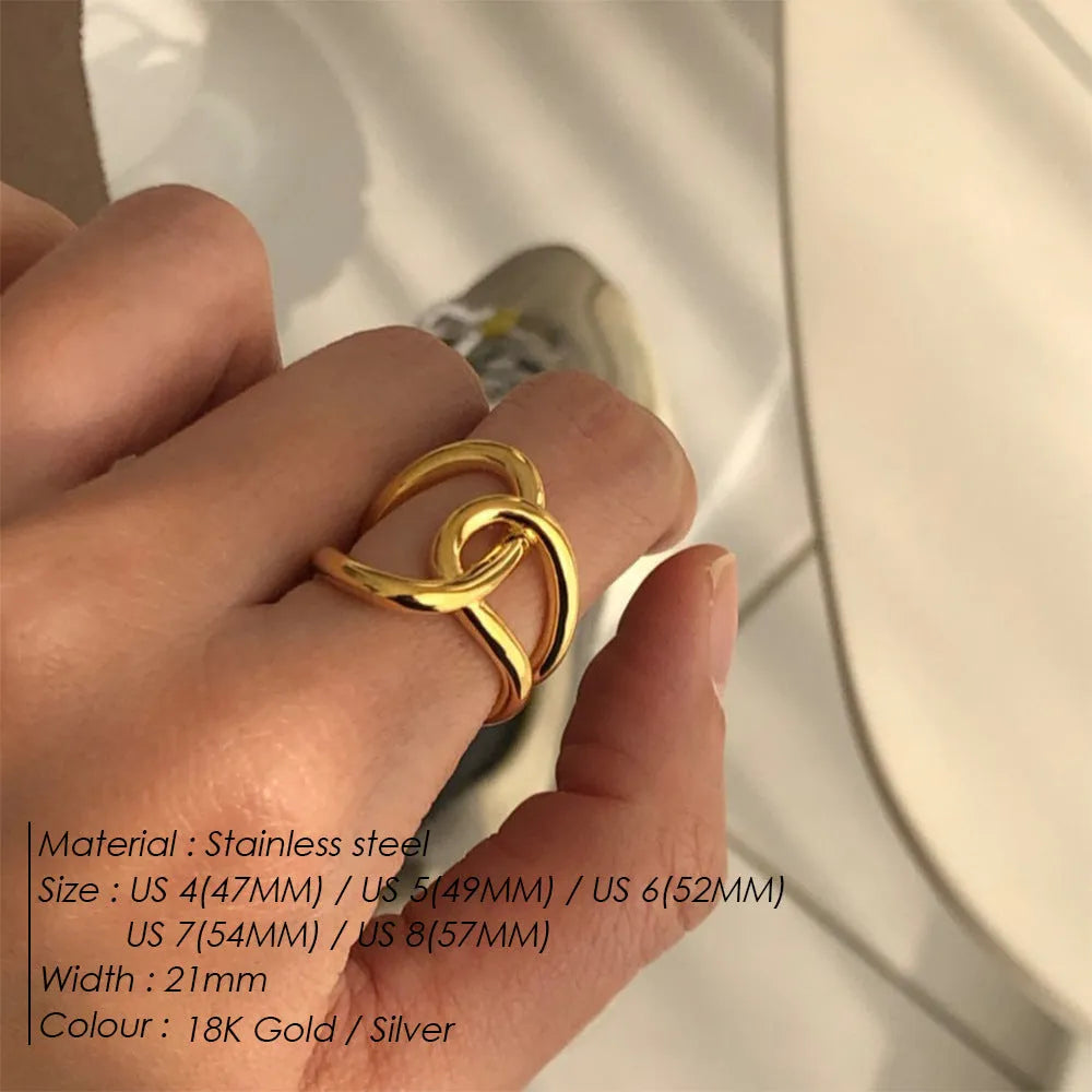 Women's stainless steel adjustable ring with knotted geometric U-shape design in gold or steel colour.