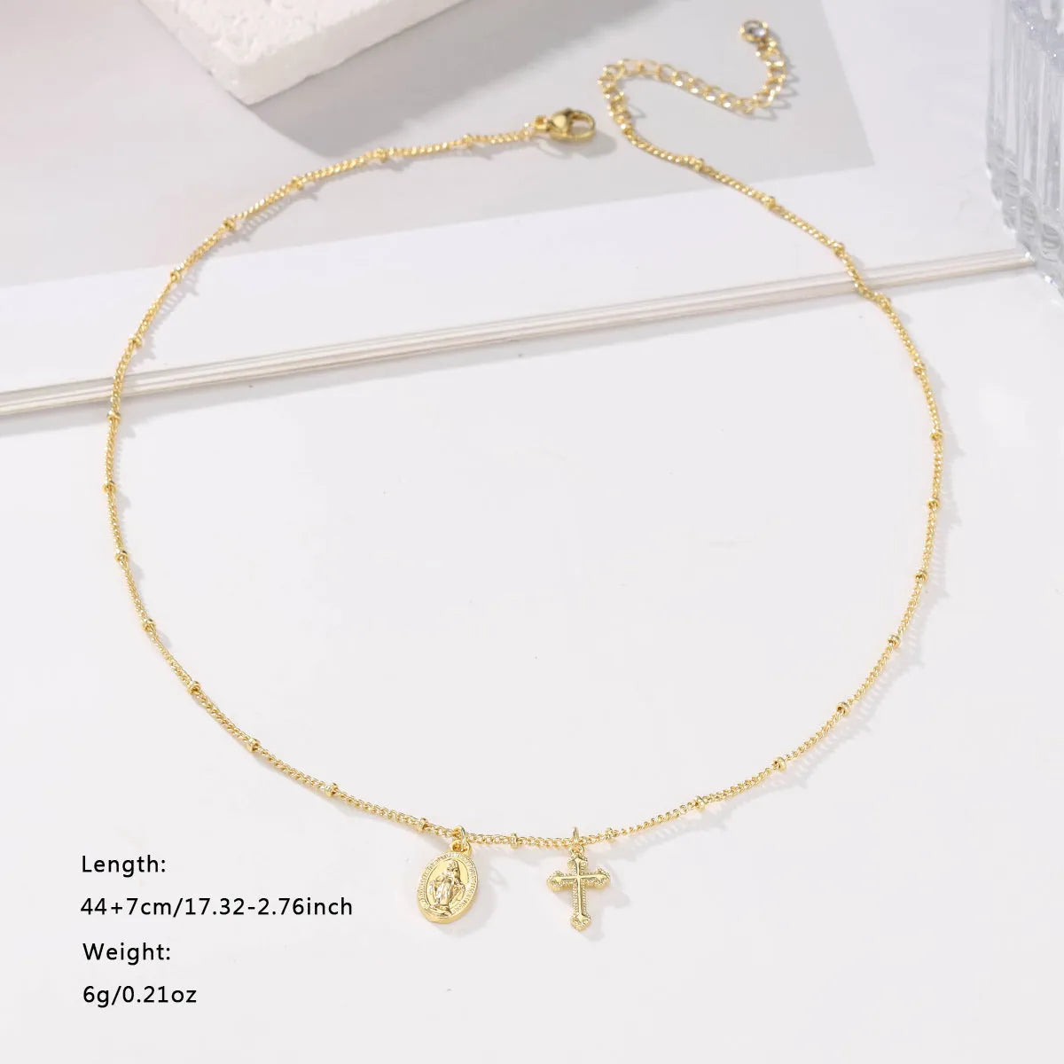 Virgin Mary geometric cross necklace in gold colour with 18k gold-plated copper construction
