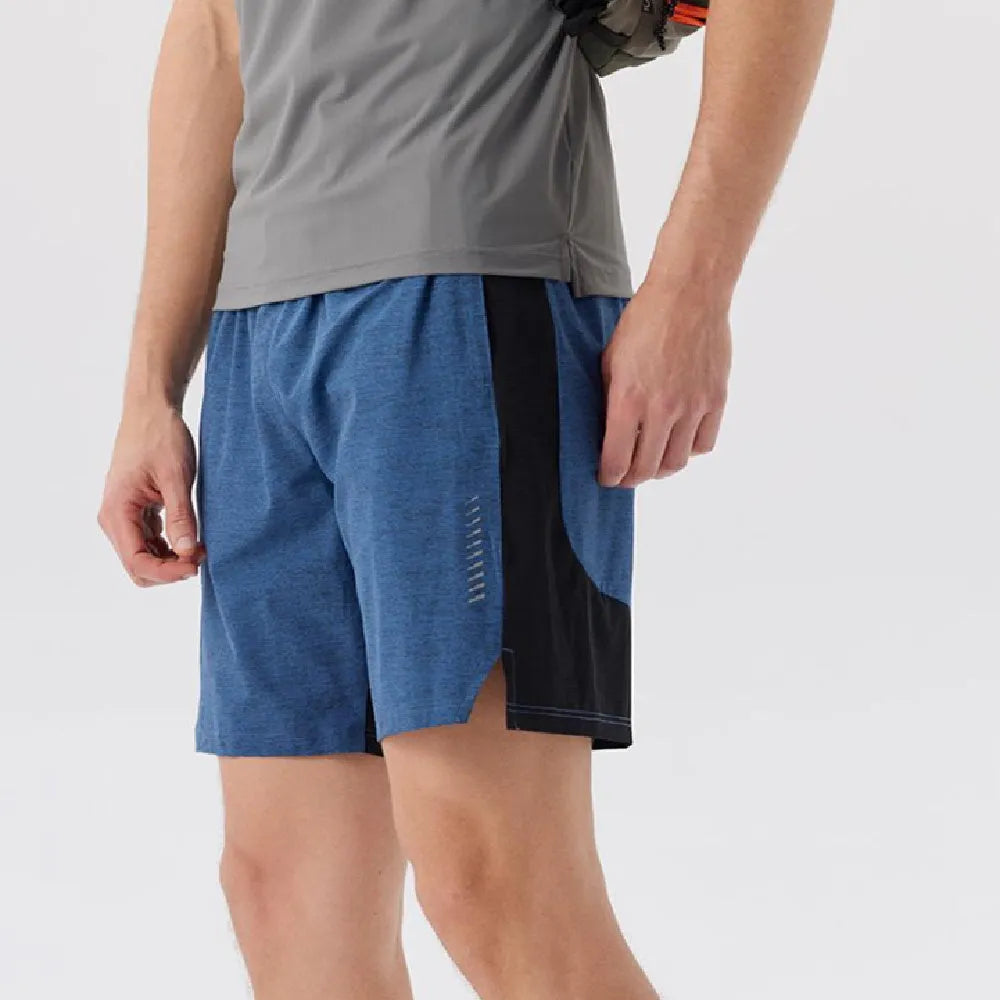 Man wearing forest green five-point spandex casual shorts with a mid waist.