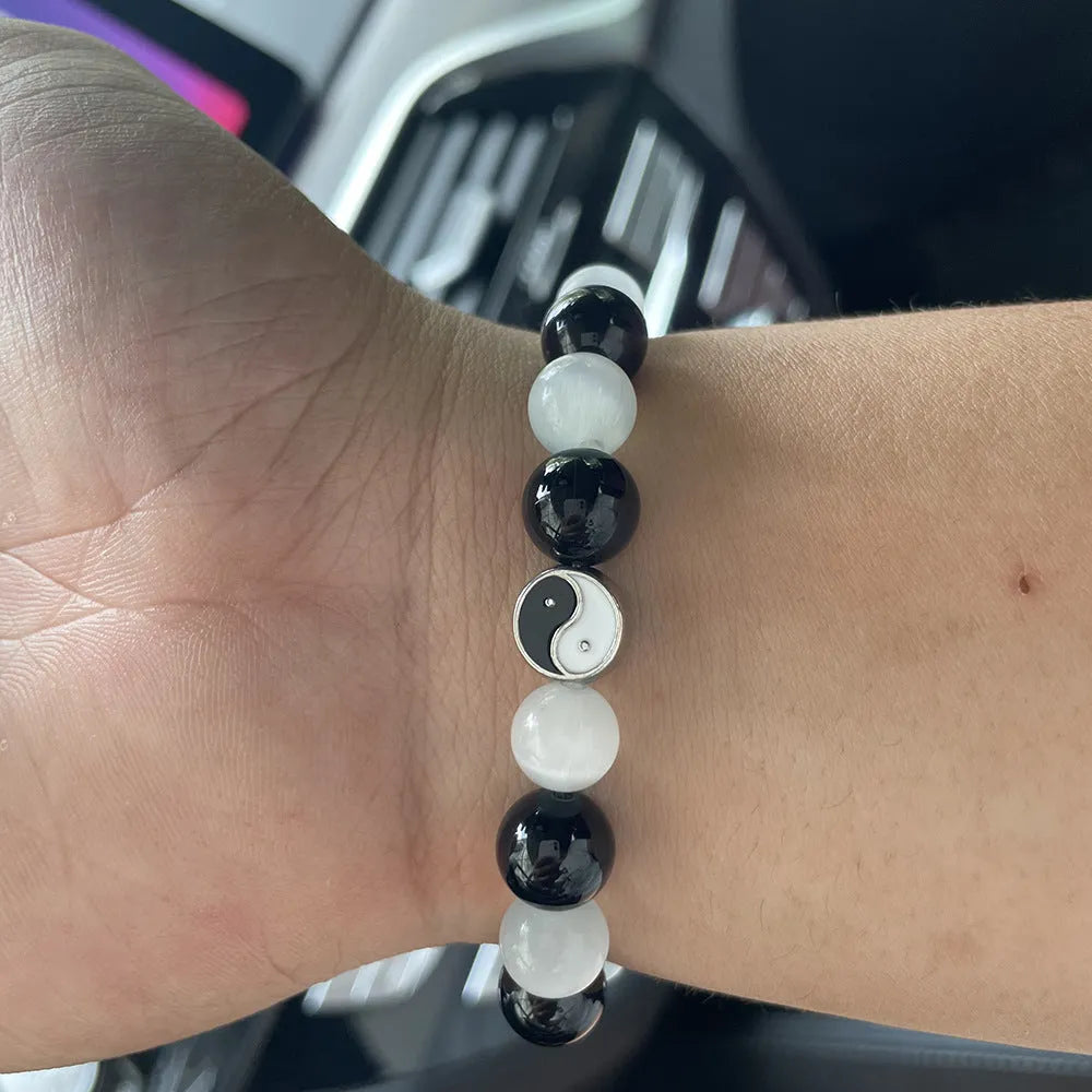Natural stone opal agate Tai Chi bracelet with 10mm polished beads and black agate detail, unisex design on neutral background