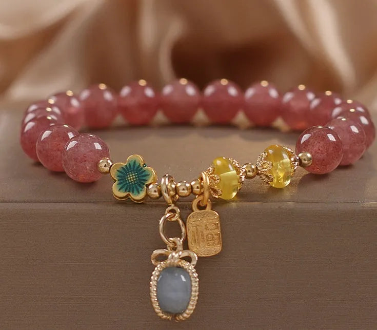 Natural Strawberry Quartz beaded bracelet with rhinestone accents on red alloy base