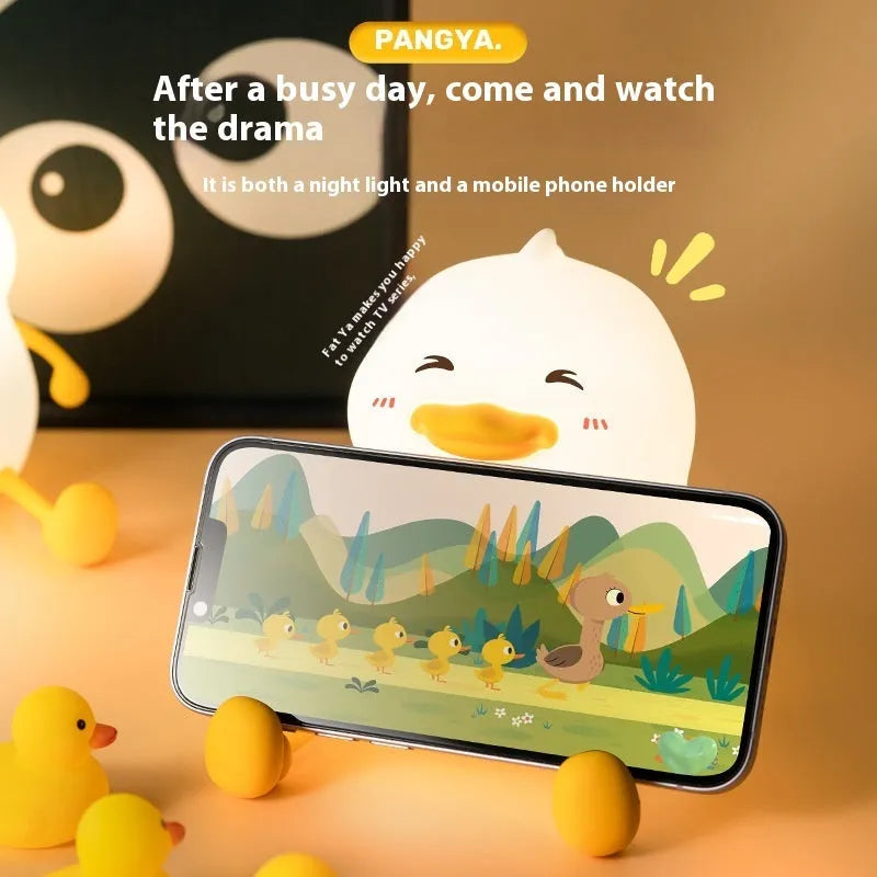 Chubby silicone night lamp with phone holder function showing compact design and adjustable LED lighting