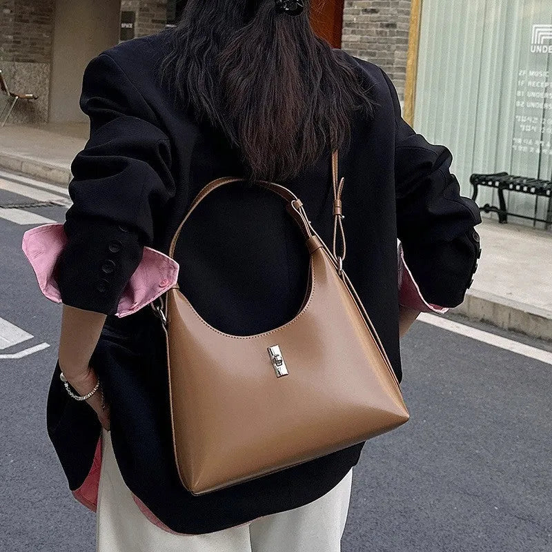 Soft brown genuine leather dumpling-shaped crossbody bag with a front sandwich pocket.